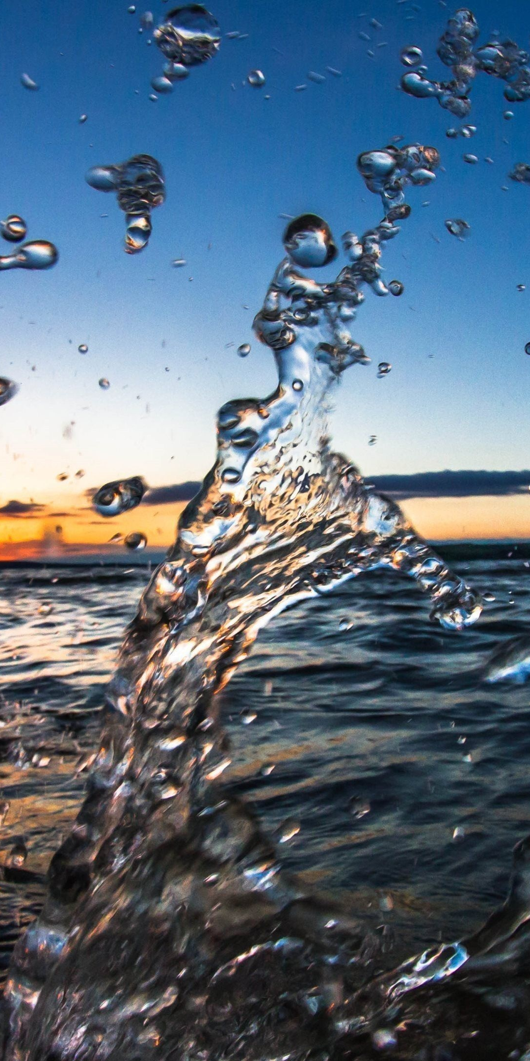 Water splashes, sea, sunset, close up, 1080x2160 wallpaper
