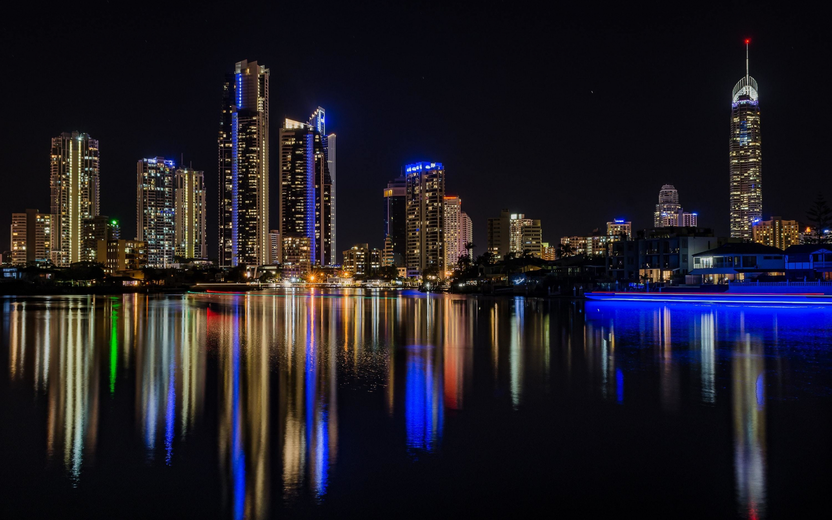 Download 1680x1050 wallpaper city, reflections, buildings, night