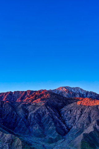Blue sky, mountains, glowing summits, sunset, 240x320 wallpaper
