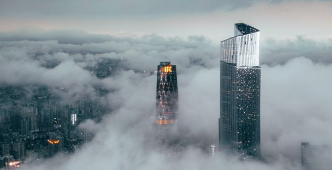 Clouds cover buildings, city wallpaper