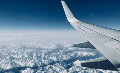 Airplane, wing, clouds, mountains, aerial view