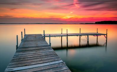 Wooden pier, calm lake, sunset