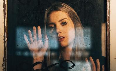 Woman behind glass, blonde, pretty