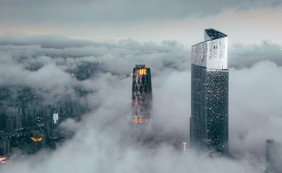 Clouds cover buildings, city