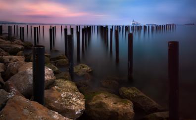 Seascape, sunset, wooden poles